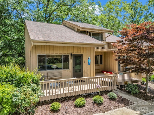 140 W Lake Dr Unit 301, Lake Lure, NC 28746 - view of front of house featuring roof with shingles, board and batten siding, and a deck