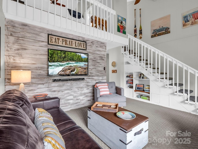 140 W Lake Dr Unit 301, Lake Lure, NC 28746 - carpeted living area featuring stairs, a towering ceiling, and wood walls