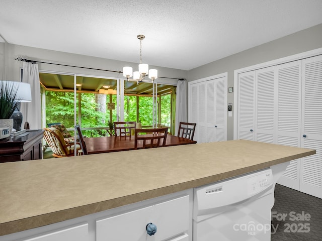140 W Lake Dr Unit 301, Lake Lure, NC 28746 - kitchen with white dishwasher, a chandelier, white cabinetry, decorative light fixtures, and light countertops