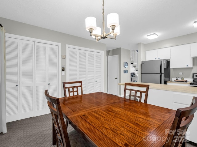 140 W Lake Dr Unit 301, Lake Lure, NC 28746 - dining space featuring a chandelier and dark colored carpet