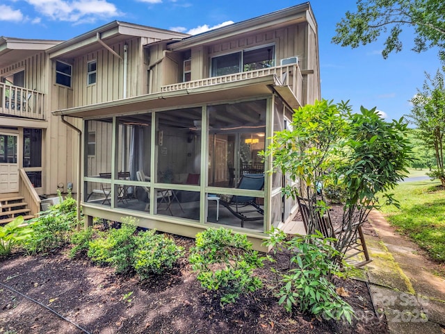 140 W Lake Dr Unit 301, Lake Lure, NC 28746 - rear view of property featuring board and batten siding, a balcony, and a sunroom