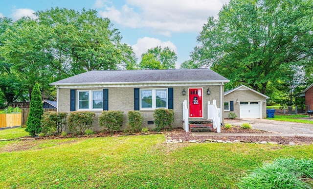 122 15th Ave NW, Hickory, NC 28601 - view of front of house with an outbuilding, asphalt driveway, brick siding, a shingled roof, and a garage