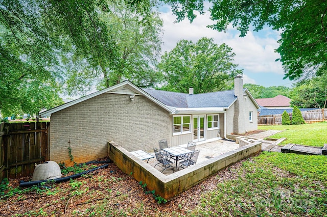 122 15th Ave NW, Hickory, NC 28601 - back of property with a patio, a chimney, brick siding, and a fenced backyard