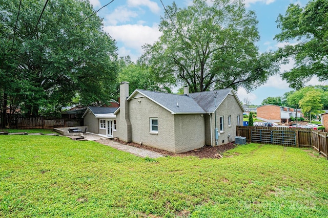 122 15th Ave NW, Hickory, NC 28601 - back of property featuring a chimney, a fenced backyard, and a patio area