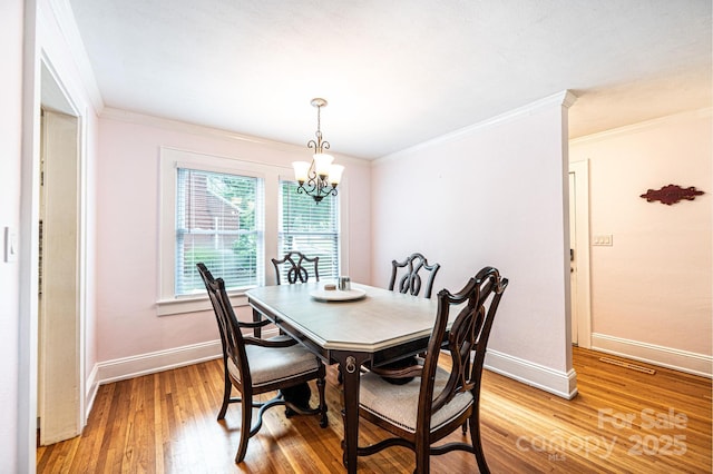 122 15th Ave NW, Hickory, NC 28601 - dining space with a chandelier, light wood-type flooring, and crown molding