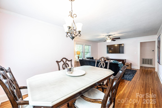 122 15th Ave NW, Hickory, NC 28601 - dining area featuring light wood-style floors, a chandelier, a ceiling fan, and crown molding