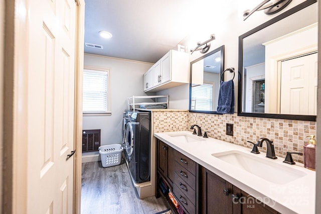 122 15th Ave NW, Hickory, NC 28601 - bathroom with washing machine and clothes dryer, wood finished floors, ornamental molding, backsplash, and double vanity