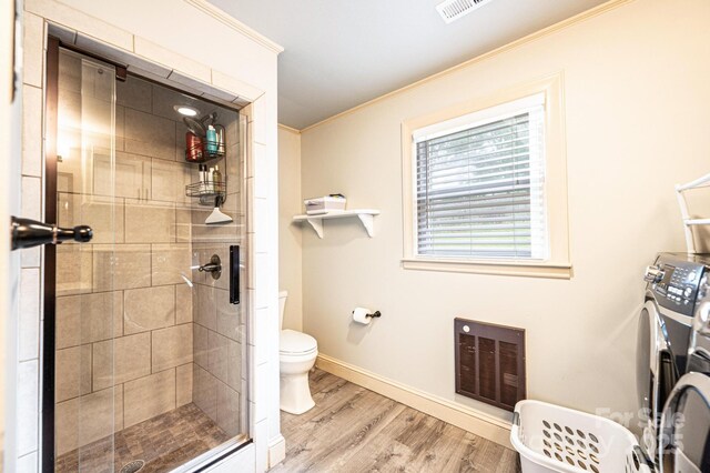 122 15th Ave NW, Hickory, NC 28601 - full bath featuring ornamental molding, wood finished floors, a stall shower, heating unit, and washing machine and dryer