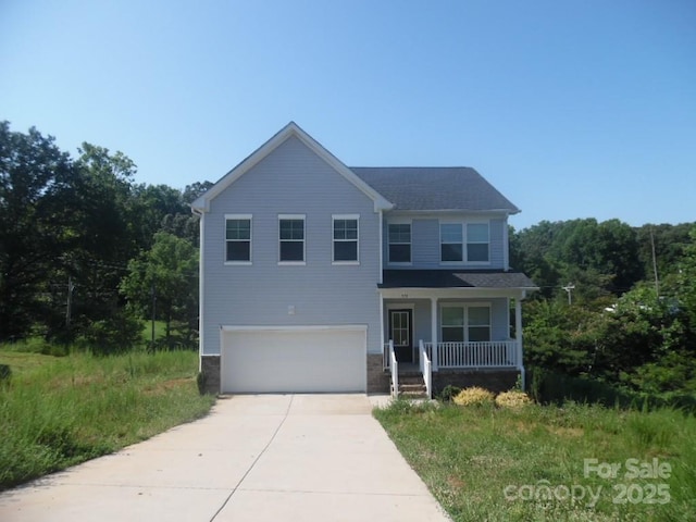 570 30th Avenue Cir NE, Hickory, NC 28601 - view of front of home with concrete driveway, a porch, a garage, and a wooded view