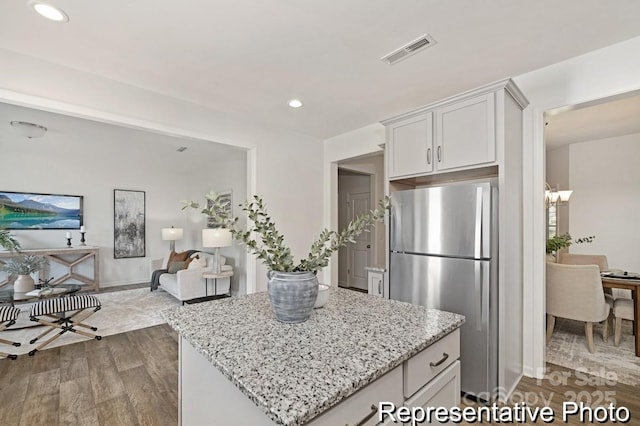 130 Fairfield Dr Unit 20, Troutman, NC 28166 - kitchen with freestanding refrigerator, dark wood-style floors, light stone counters, recessed lighting, and a kitchen island