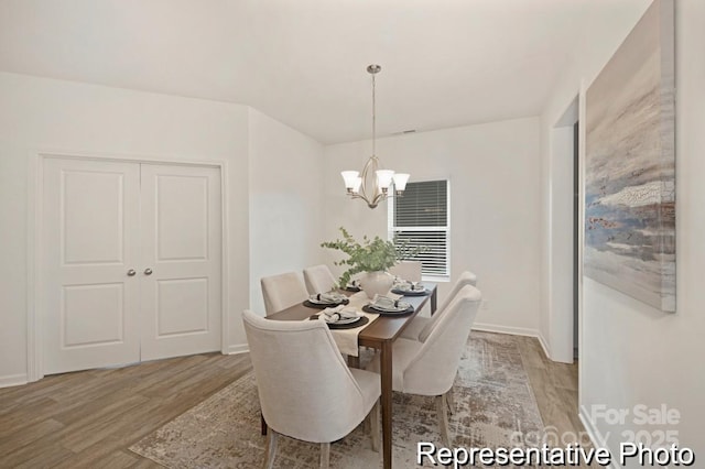 130 Fairfield Dr Unit 20, Troutman, NC 28166 - dining area with light wood finished floors and a chandelier