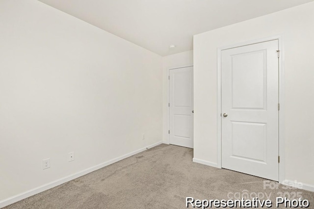 130 Fairfield Dr Unit 20, Troutman, NC 28166 - unfurnished bedroom featuring baseboards and light carpet