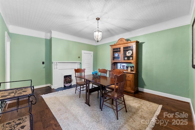 262 8th Ave, Cramerton, NC 28032 - dining space featuring a fireplace with flush hearth, dark wood-type flooring, and crown molding