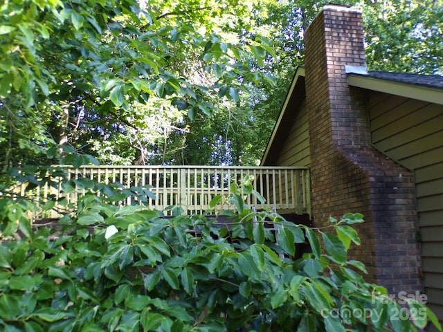 140 Beechwood Cir, Hendersonville, NC 28739 - view of home's exterior featuring a chimney and a wooden deck