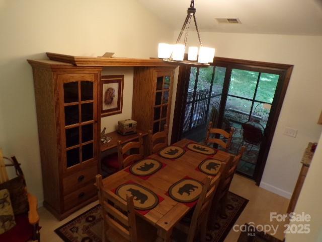 140 Beechwood Cir, Hendersonville, NC 28739 - dining room featuring a chandelier and vaulted ceiling