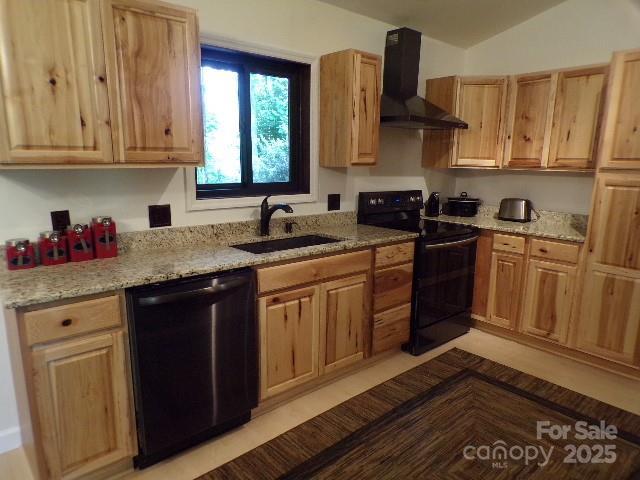 140 Beechwood Cir, Hendersonville, NC 28739 - kitchen with black appliances, wall chimney range hood, light stone countertops, light brown cabinetry, and vaulted ceiling