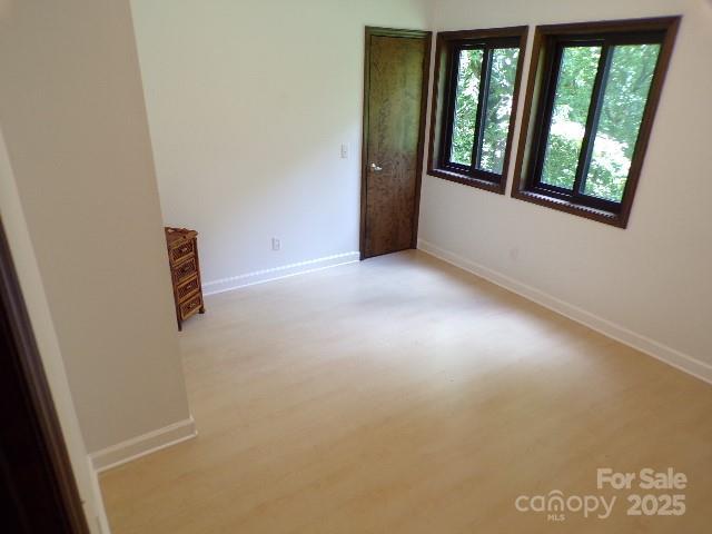 140 Beechwood Cir, Hendersonville, NC 28739 - empty room featuring light wood-style flooring and baseboards