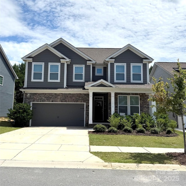 1016 Burton Point Ct, Waxhaw, NC 28173 - craftsman inspired home with concrete driveway, a garage, stone siding, and a front lawn