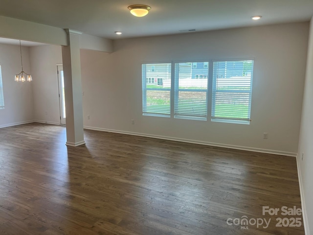 1005 Lorrie Ln Unit 84, Albemarle, NC 28001 - unfurnished room featuring dark wood-style floors, a chandelier, ornate columns, and recessed lighting