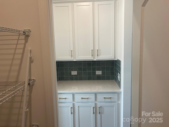 1005 Lorrie Ln Unit 84, Albemarle, NC 28001 - kitchen with tasteful backsplash, white cabinetry, and light stone counters