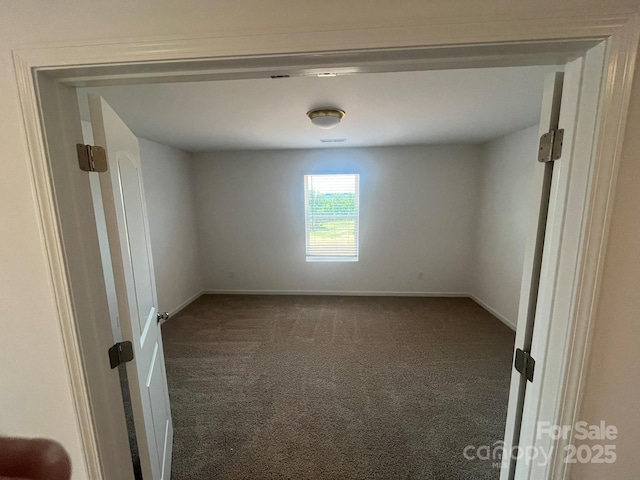 1005 Lorrie Ln Unit 84, Albemarle, NC 28001 - spare room with dark carpet and baseboards