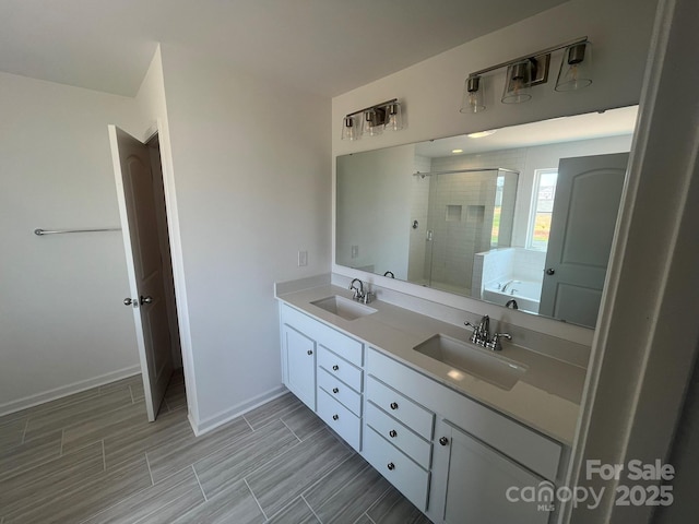 1005 Lorrie Ln Unit 84, Albemarle, NC 28001 - full bathroom featuring a stall shower, double vanity, a garden tub, and wood tiled floors
