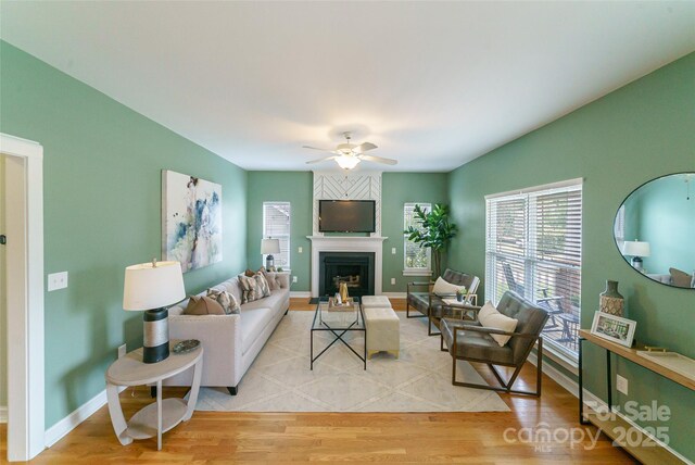 8509 Castle Cliff Dr, Matthews, NC 28105 - living area with light wood finished floors, a ceiling fan, and a fireplace