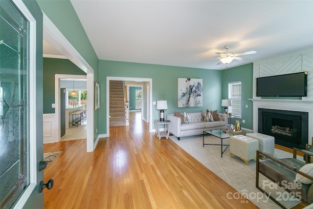 8509 Castle Cliff Dr, Matthews, NC 28105 - living room with a ceiling fan, a large fireplace, and light wood-style flooring