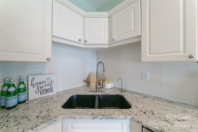 8509 Castle Cliff Dr, Matthews, NC 28105 - kitchen with backsplash, white cabinetry, and light stone countertops