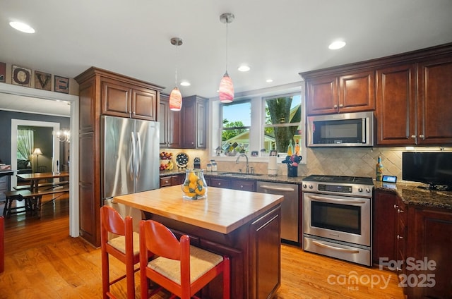 22 Poplar St, Belmont, NC 28012 - kitchen featuring appliances with stainless steel finishes, wood counters, light wood finished floors, backsplash, and recessed lighting