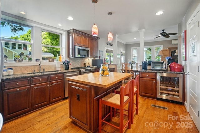 22 Poplar St, Belmont, NC 28012 - kitchen featuring wood counters, beverage cooler, light wood-style flooring, backsplash, and recessed lighting