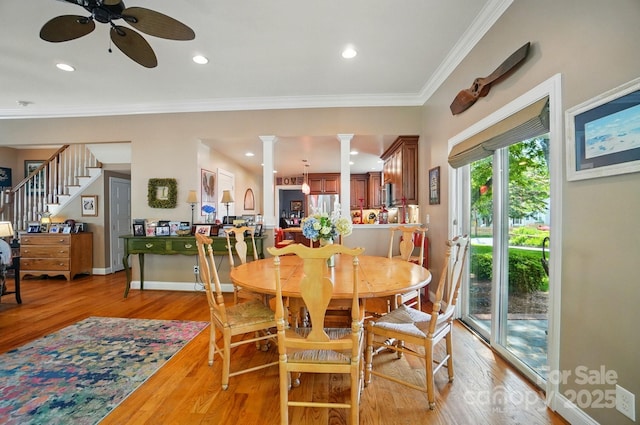 22 Poplar St, Belmont, NC 28012 - dining room with ceiling fan, light wood-style floors, decorative columns, stairs, and ornamental molding