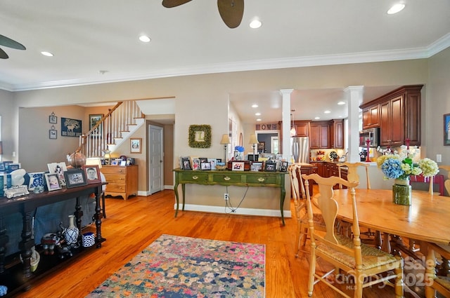 22 Poplar St, Belmont, NC 28012 - dining room with ceiling fan, decorative columns, light wood-type flooring, stairway, and crown molding