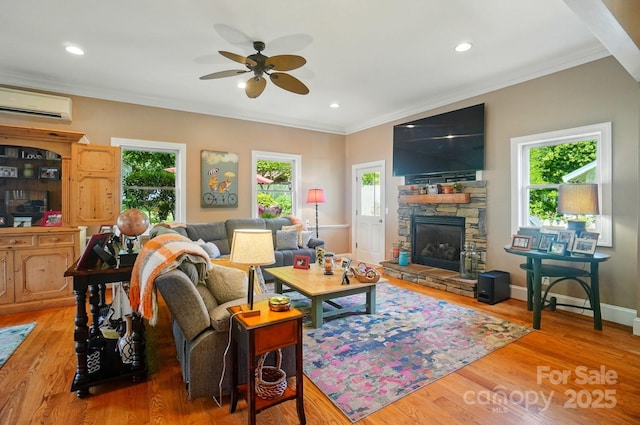 22 Poplar St, Belmont, NC 28012 - living area featuring ceiling fan, ornamental molding, a stone fireplace, a wall mounted AC, and wood finished floors