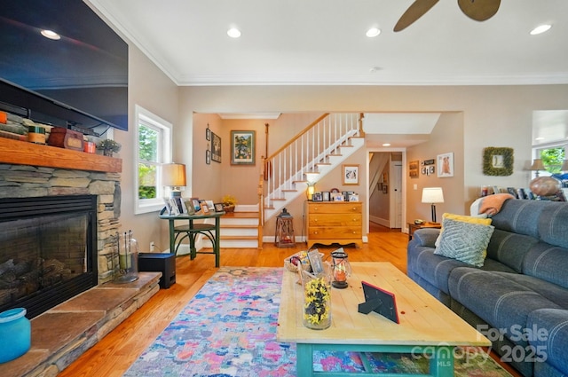 22 Poplar St, Belmont, NC 28012 - living room featuring stairway, ornamental molding, ceiling fan, a stone fireplace, and wood finished floors