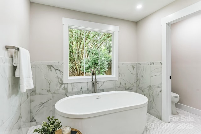 1208 Tarrington Ave, Charlotte, NC 28205 - full bathroom featuring tile walls, a soaking tub, a wainscoted wall, and recessed lighting
