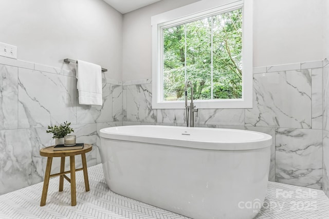 1208 Tarrington Ave, Charlotte, NC 28205 - bathroom with tile walls, a wainscoted wall, and a freestanding tub