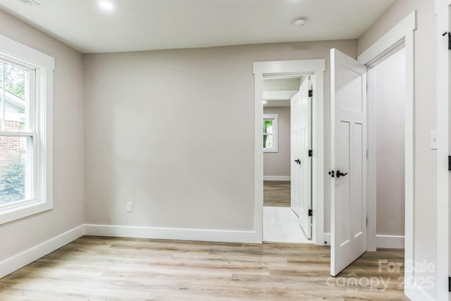 1208 Tarrington Ave, Charlotte, NC 28205 - empty room featuring light wood-type flooring and a smoke detector