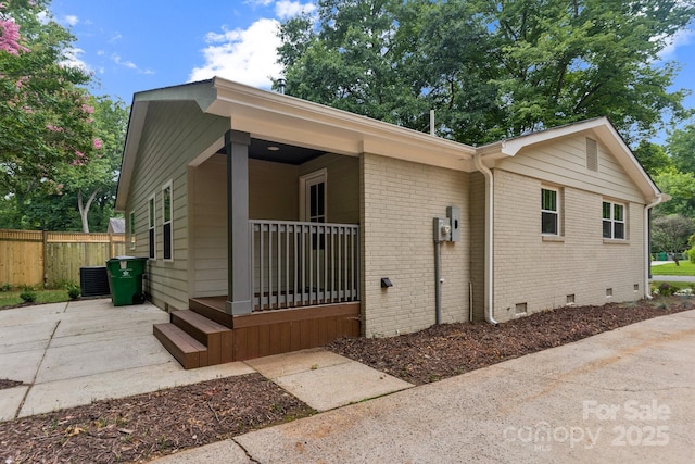 1208 Tarrington Ave, Charlotte, NC 28205 - view of property exterior featuring crawl space, covered porch, and brick siding