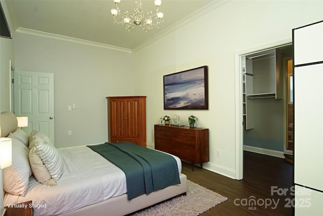 3974 Pleasant Plains Rd, Matthews, NC 28104 - bedroom featuring crown molding, a spacious closet, a chandelier, and dark wood finished floors