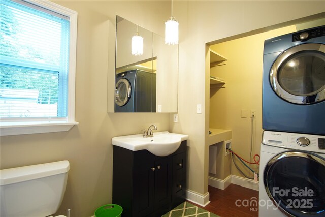 3974 Pleasant Plains Rd, Matthews, NC 28104 - bathroom with stacked washer / drying machine, vanity, healthy amount of natural light, and wood finished floors