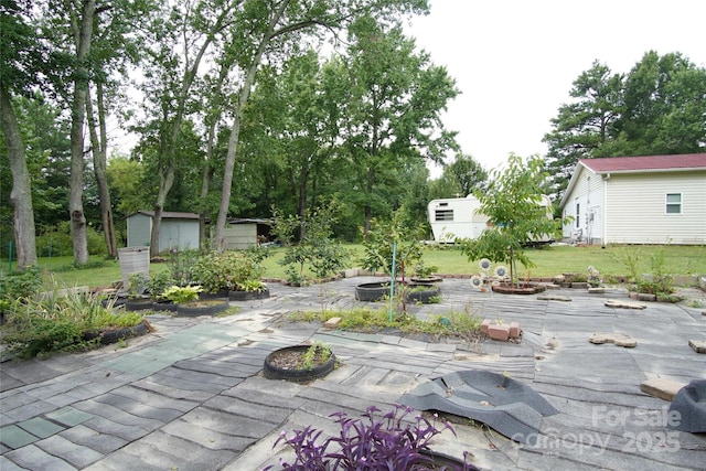 3974 Pleasant Plains Rd, Matthews, NC 28104 - view of patio / terrace featuring a storage unit and view of scattered trees