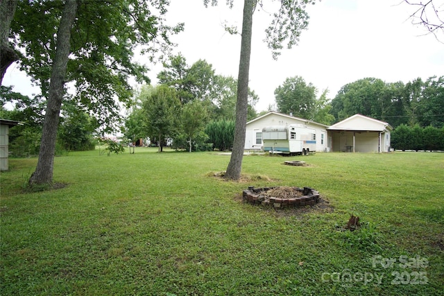 3974 Pleasant Plains Rd, Matthews, NC 28104 - view of grassy yard with an outdoor fire pit
