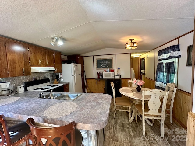 492 Chestnut Mountain Rd, Spruce Pine, NC 28777 - kitchen with wood finished floors, lofted ceiling, wood walls, white appliances, and wainscoting