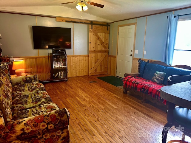 492 Chestnut Mountain Rd, Spruce Pine, NC 28777 - living room with hardwood / wood-style flooring, a ceiling fan, wood walls, wainscoting, and lofted ceiling