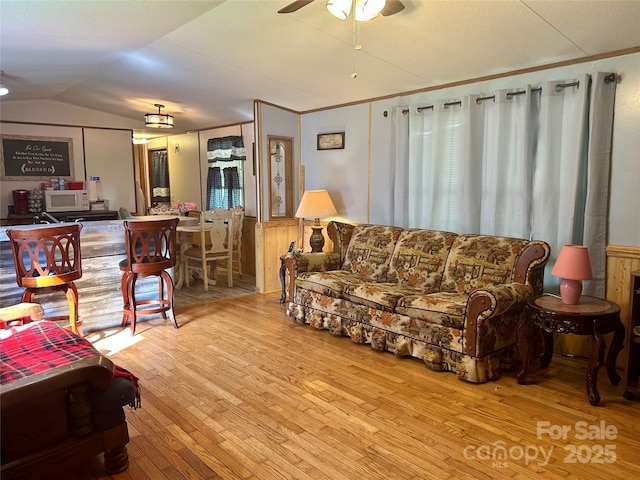 492 Chestnut Mountain Rd, Spruce Pine, NC 28777 - living room featuring a ceiling fan, hardwood / wood-style floors, lofted ceiling, and a wainscoted wall
