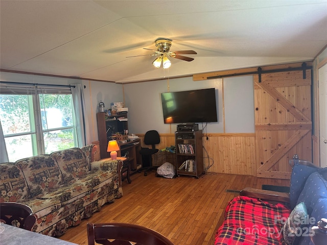 492 Chestnut Mountain Rd, Spruce Pine, NC 28777 - living room featuring a ceiling fan, vaulted ceiling, hardwood / wood-style flooring, wood walls, and wainscoting