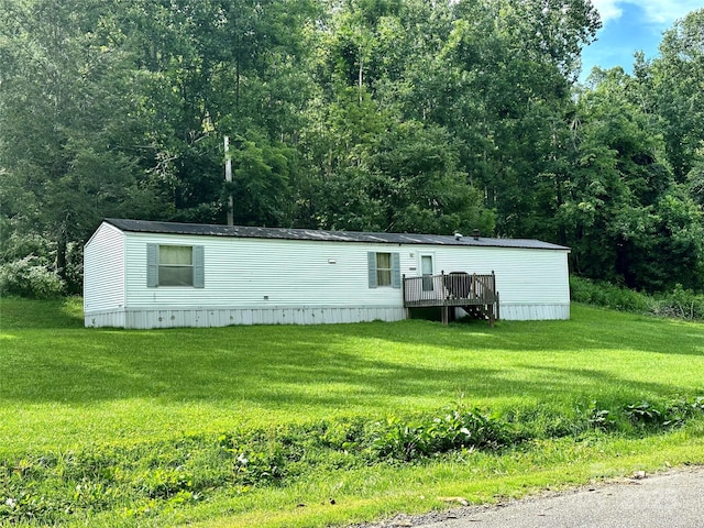 492 Chestnut Mountain Rd, Spruce Pine, NC 28777 - manufactured / mobile home with a deck, a front yard, and a wooded view