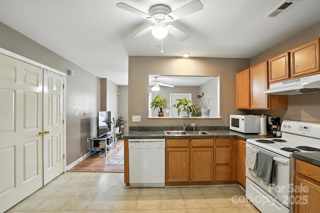 113 Steam Engine Dr Unit 108, Mooresville, NC 28115 - kitchen featuring ceiling fan, white appliances, dark countertops, under cabinet range hood, and brown cabinets