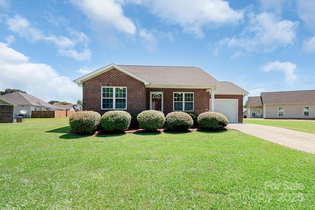 169 Abigail Ln, Locust, NC 28097 - ranch-style house featuring an attached garage, driveway, brick siding, and a front lawn